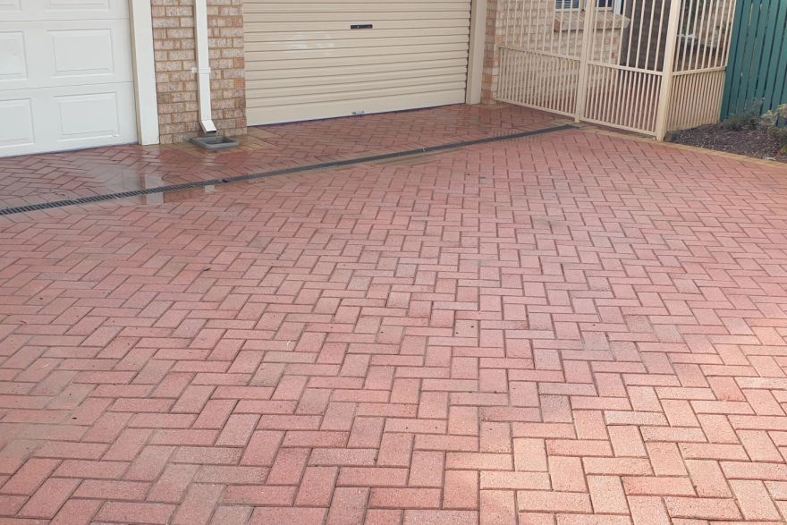 Before and after cleaning on brick pavers · Driveway: after