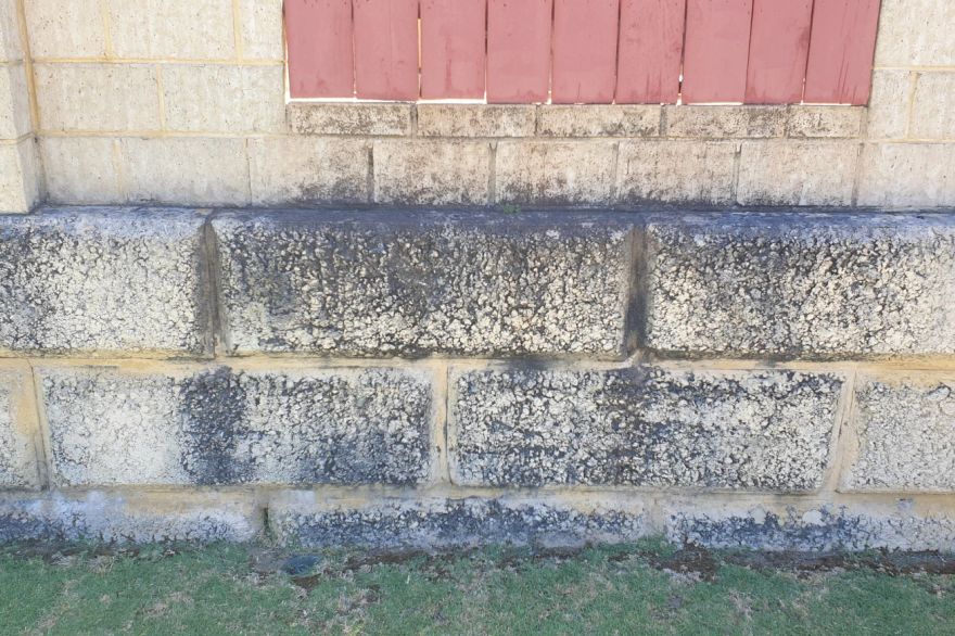 Before and after cleaning on limestone block: before
