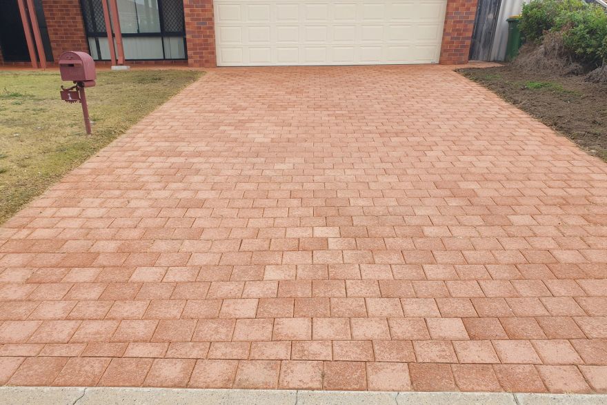 Before and after cleaning on brick pavers · Driveway: after