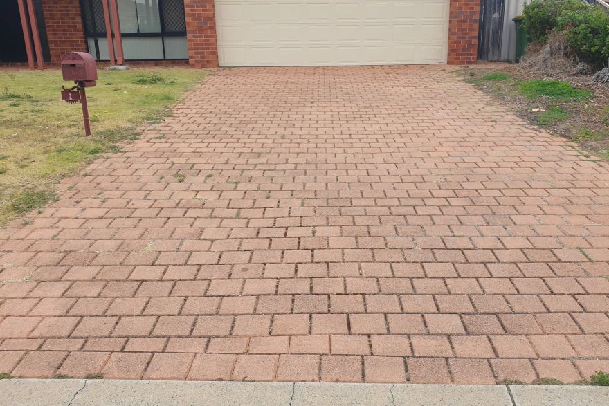 Before and after cleaning on brick pavers · Driveway: before