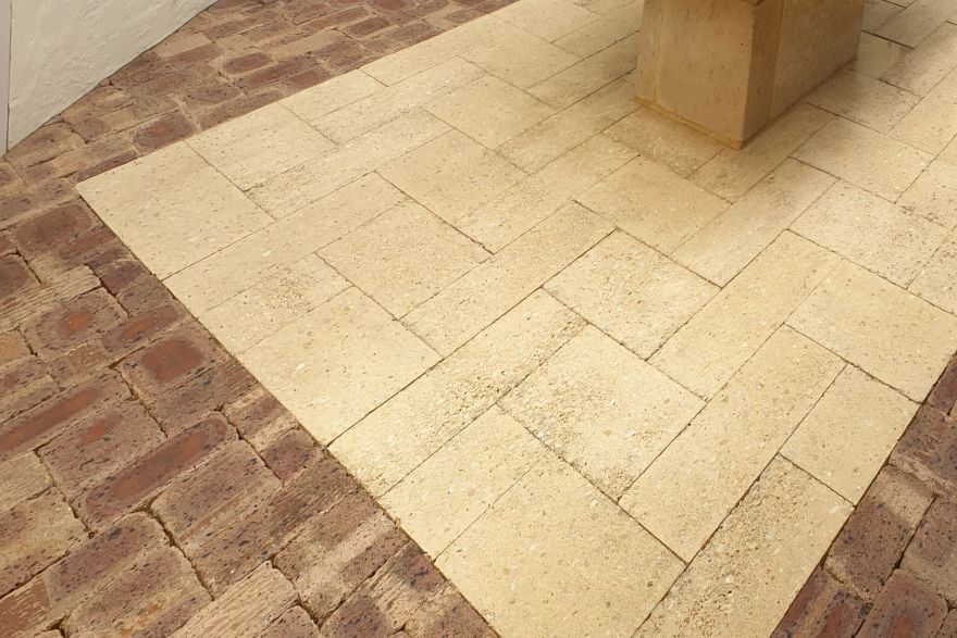 Before and after cleaning on brick pavers · Patio / alfresco: after