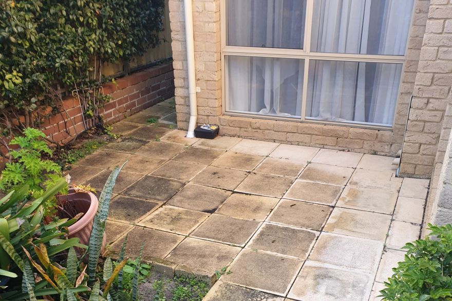 Before and after cleaning on sandstone pavers: before