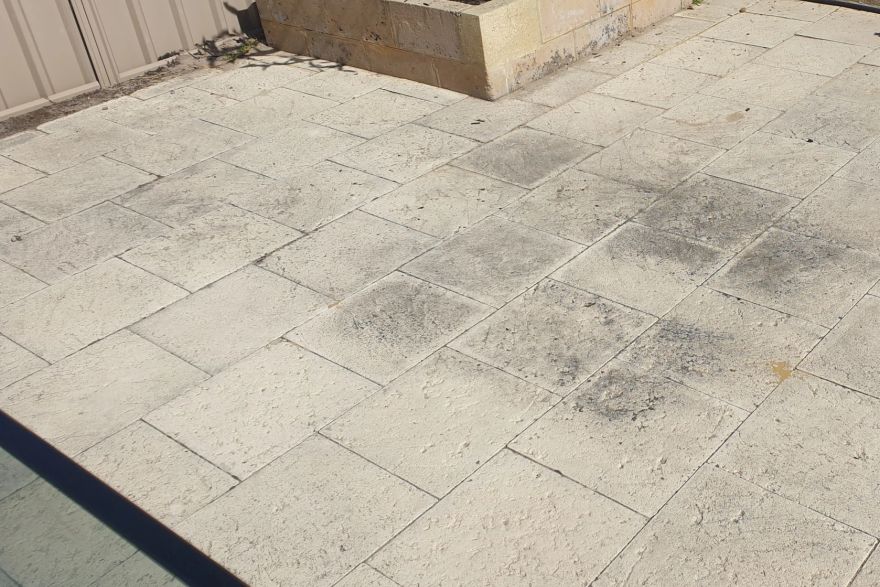 Before and after cleaning on sandstone pavers: before