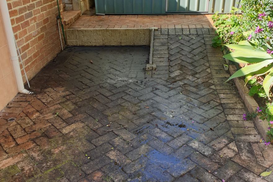 Before and after cleaning on brick pavers: before