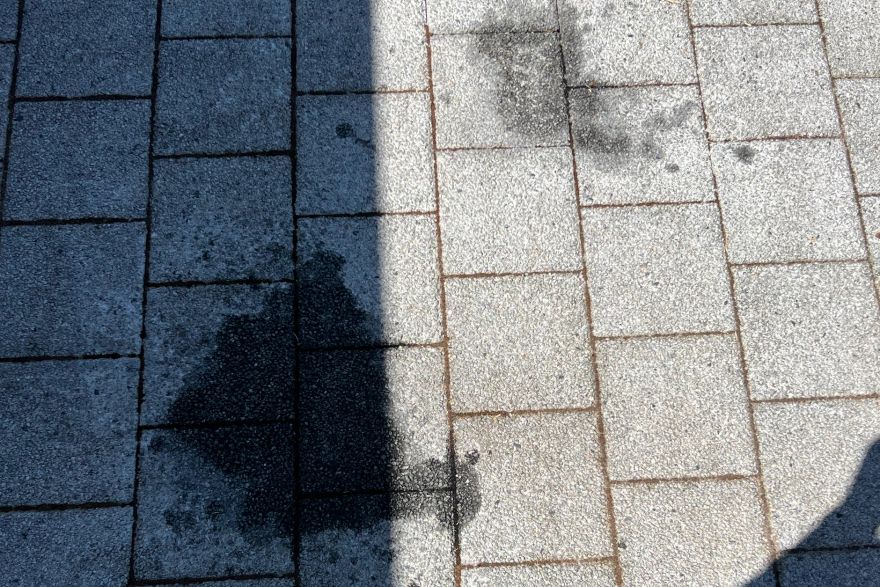 Before and after oil stains on brick pavers: before