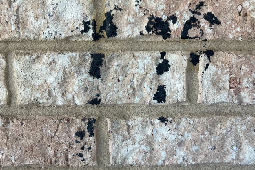 Before and after graffiti on house bricks: before
