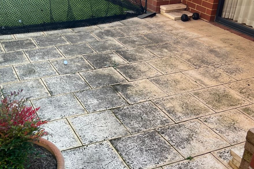 Before and after cleaning on sandstone pavers: before