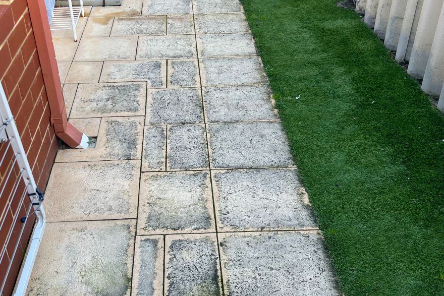 Before and after cleaning on sandstone pavers: before