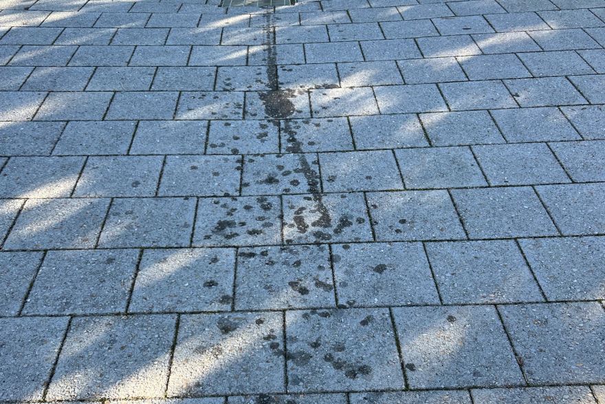 Before and after oil stains on brick pavers: before