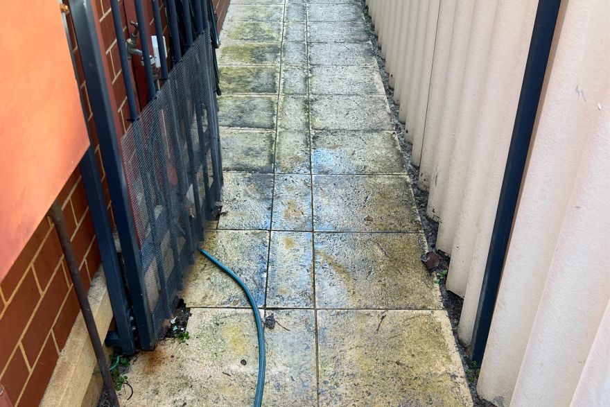 Before and after cleaning on sandstone pavers: before