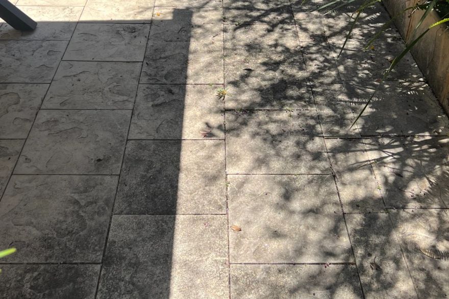 Before and after cleaning on sandstone pavers: before