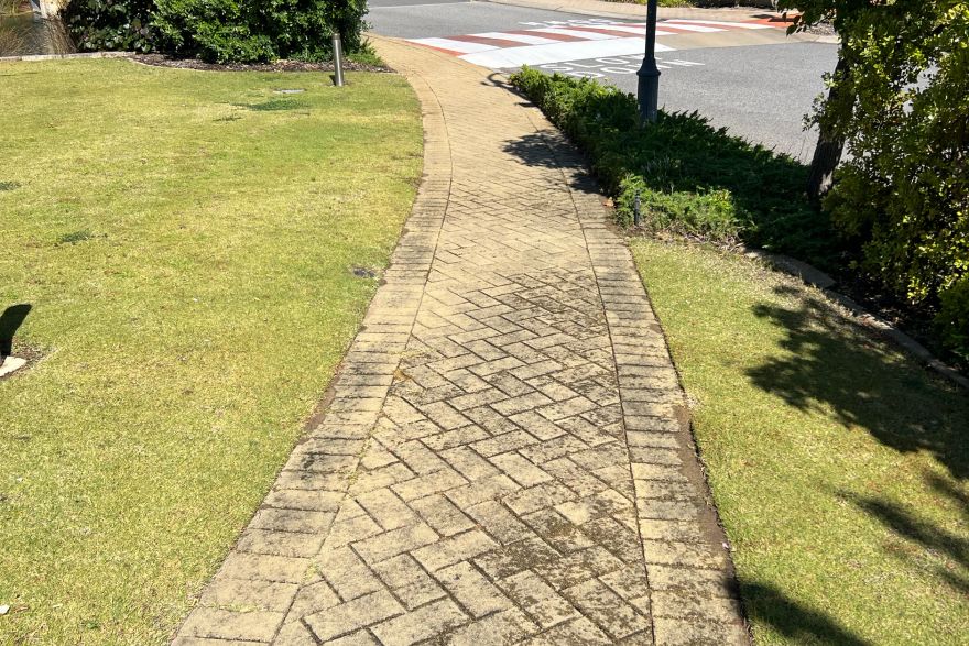 Before and after cleaning on brick pavers: before