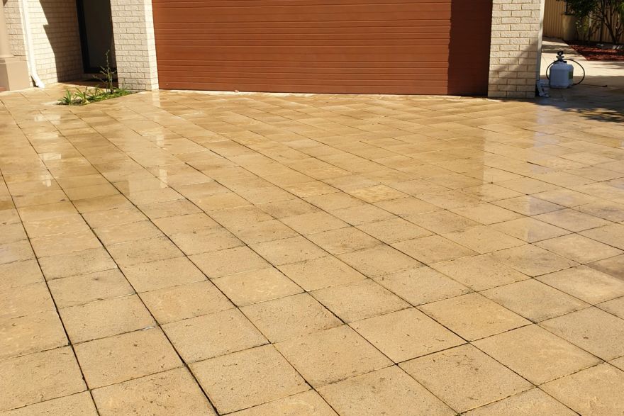 Before and after cleaning on sandstone pavers · Driveway: after
