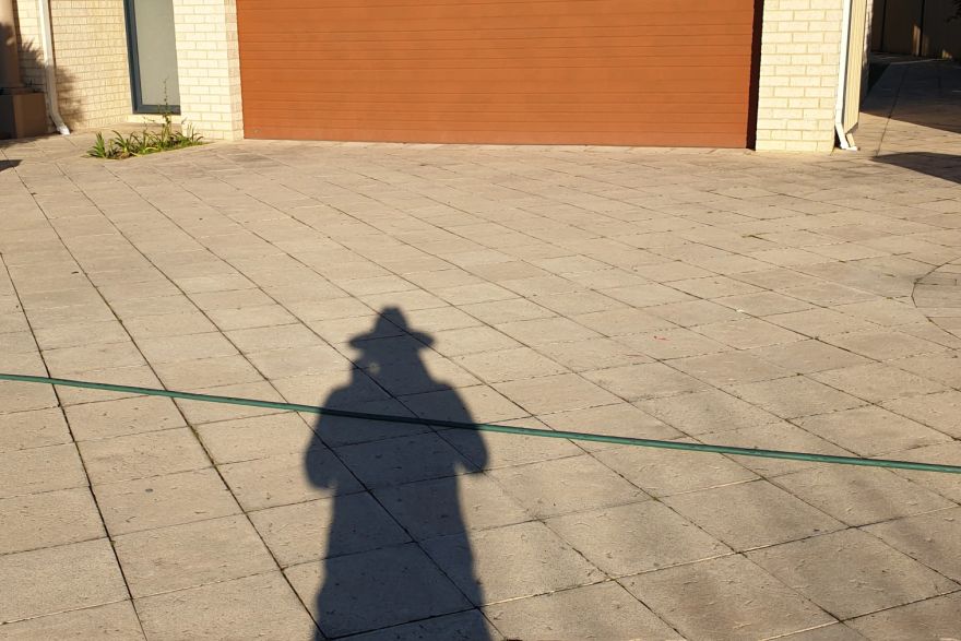 Before and after cleaning on sandstone pavers · Driveway: before