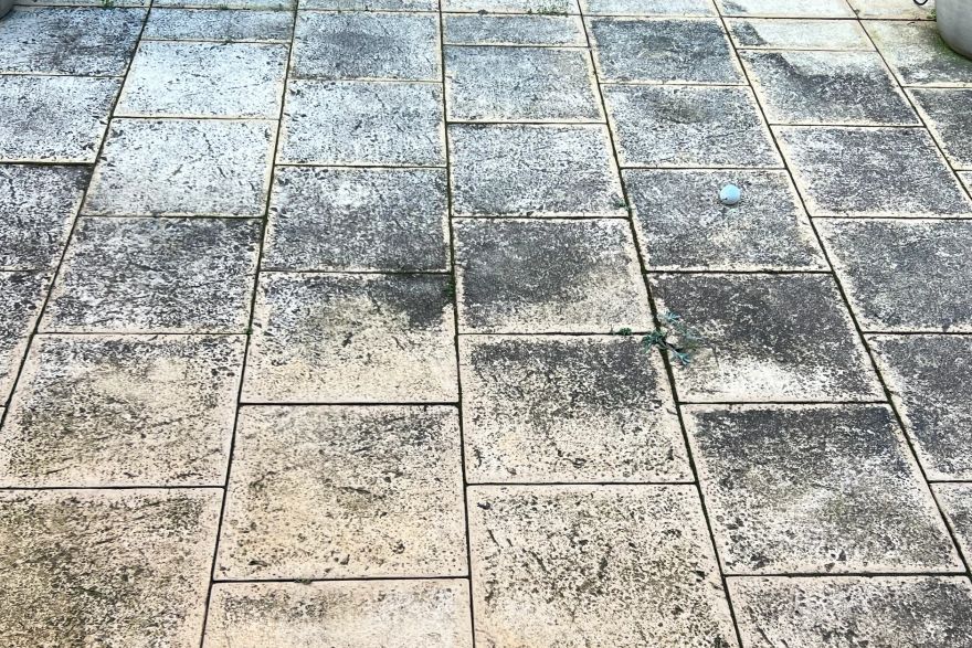Before and after cleaning on sandstone pavers: before