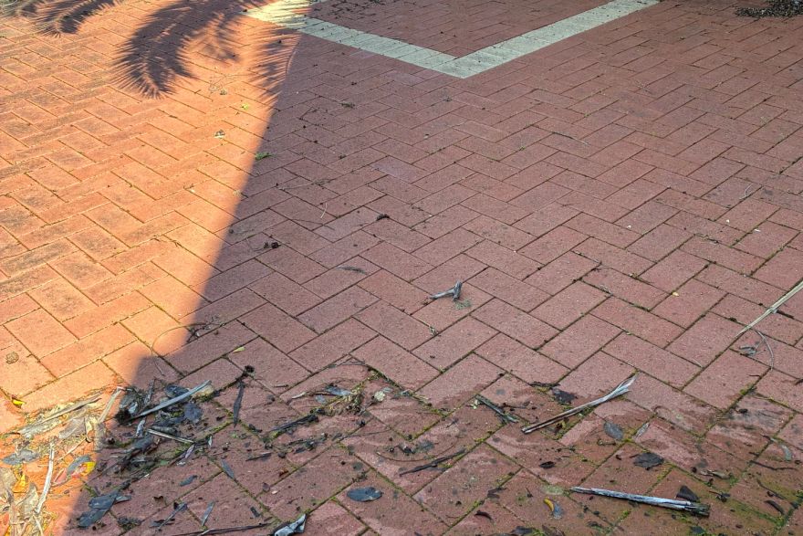 Before and after cleaning on brick pavers · Driveway: before