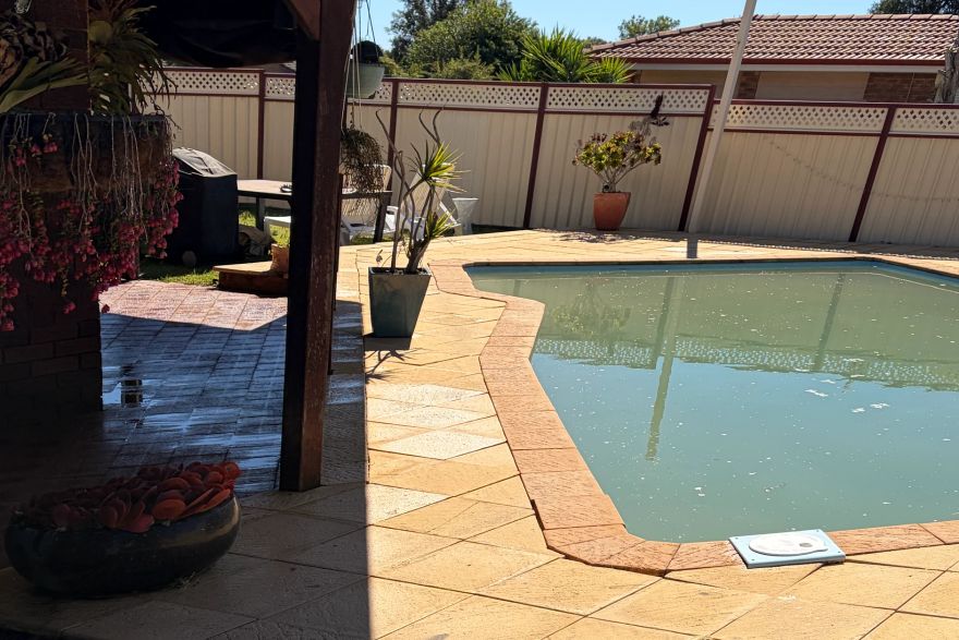 Before and after cleaning on sandstone pavers · Poolside: after