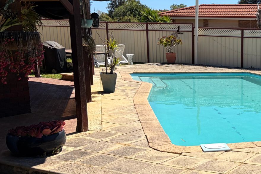 Before and after cleaning on sandstone pavers · Poolside: before