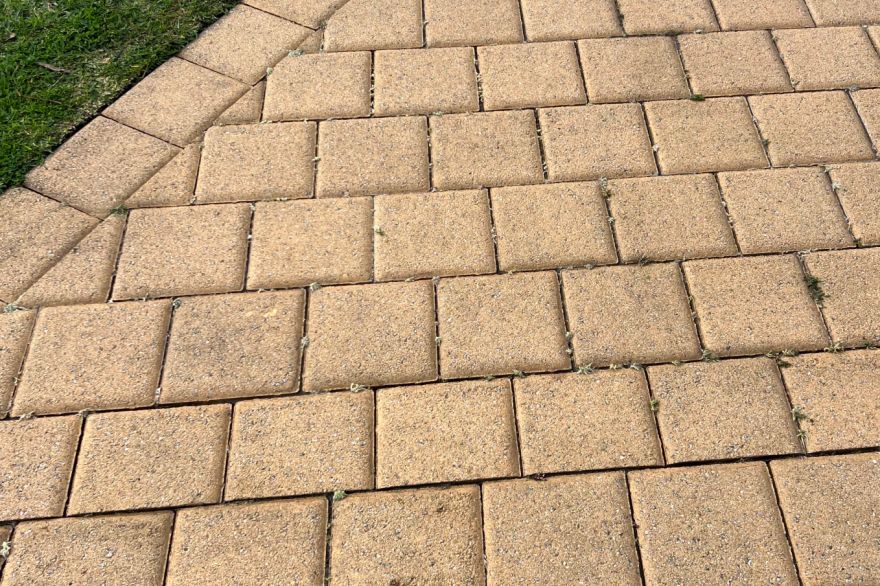 Before and after cleaning on brick pavers · Driveway: after