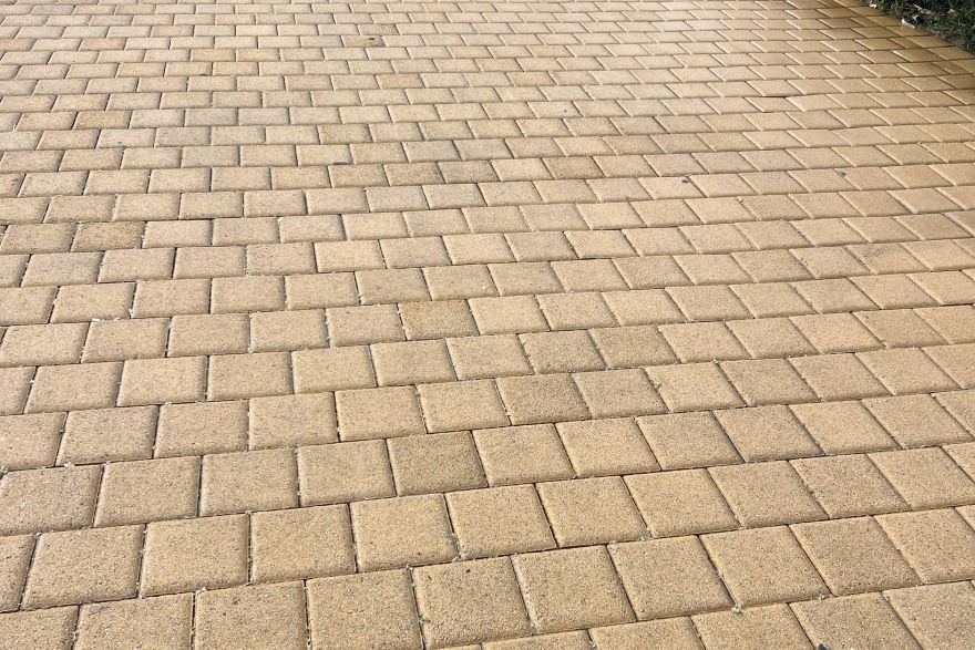 Before and after cleaning on brick pavers · Driveway: after