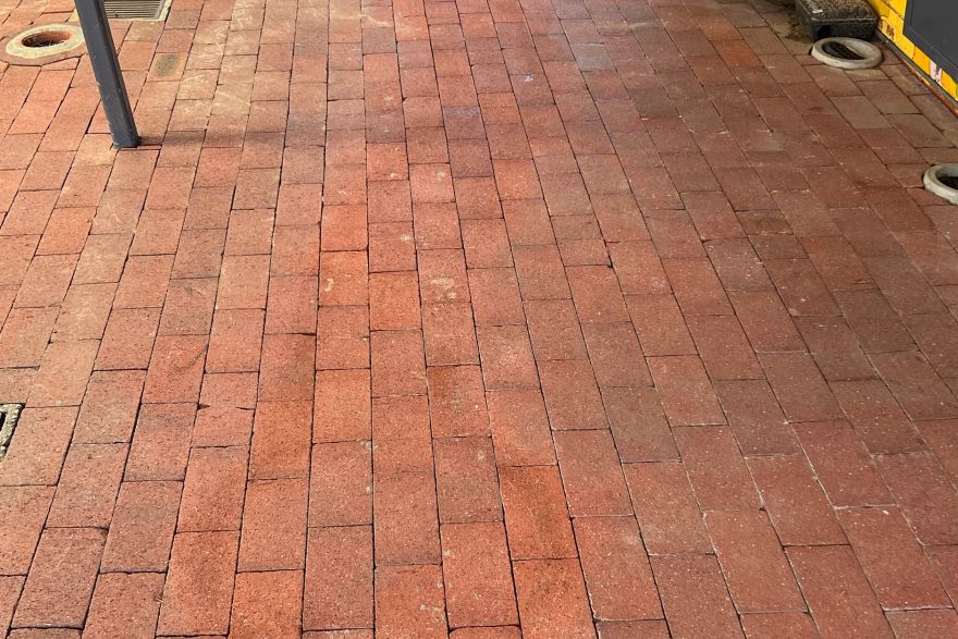Before and after paint removal on brick pavers: after
