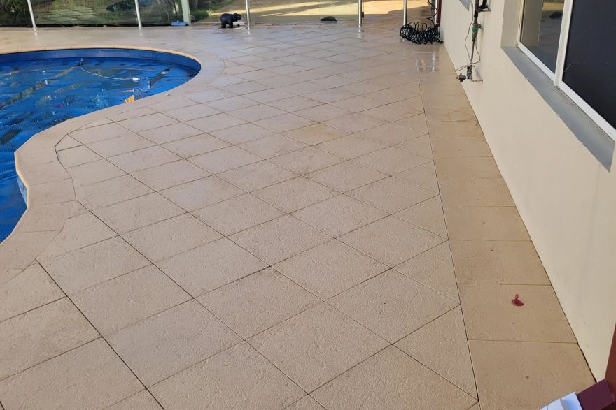 Before and after cleaning on sandstone pavers · Poolside: after