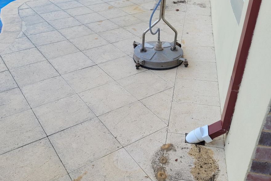 Before and after cleaning on sandstone pavers · Poolside: before