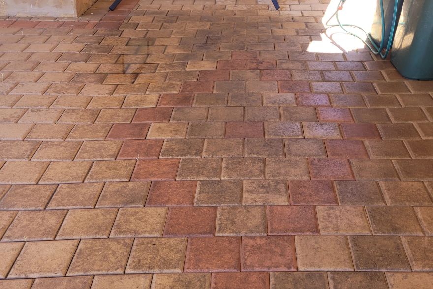 Before and after cleaning on brick pavers · Garage floor: after