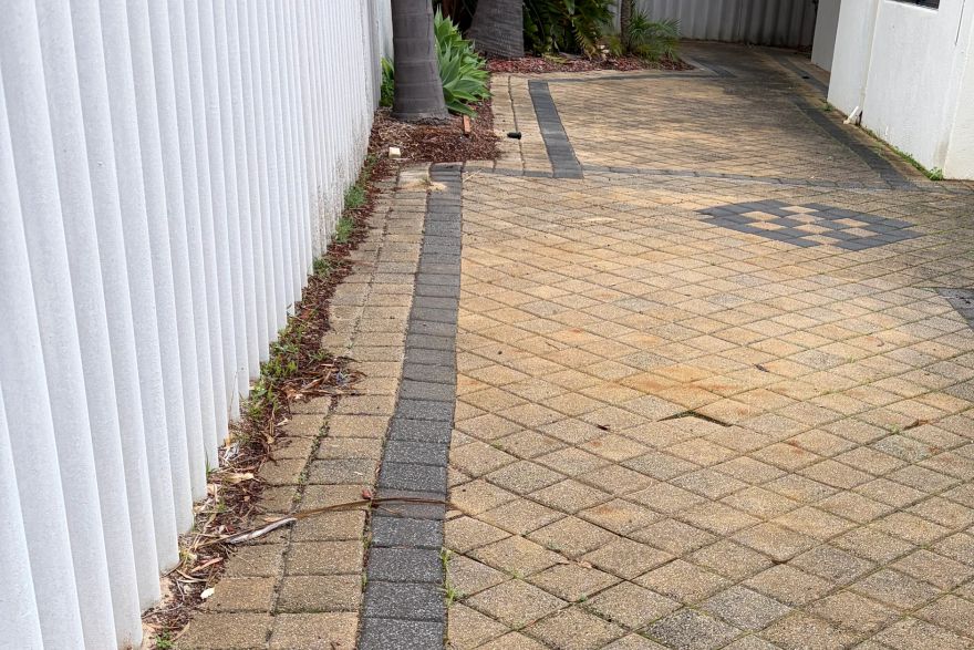 Before and after cleaning on brick pavers: before