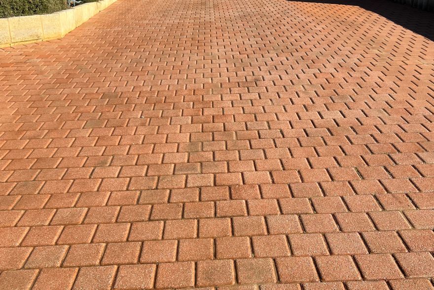 Before and after cleaning on brick pavers · Driveway: after