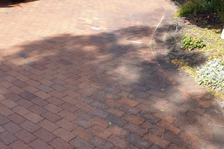 Before and after cleaning on brick pavers: before