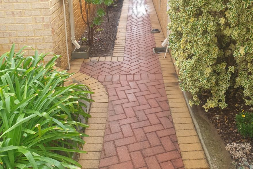 Before and after cleaning on brick pavers · Path: after