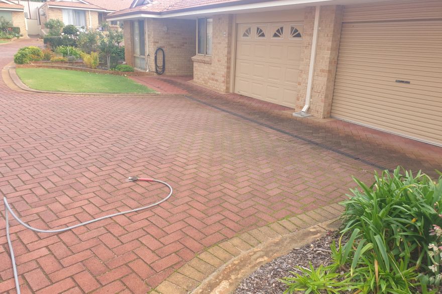 Before and after cleaning on brick pavers · Driveway: before