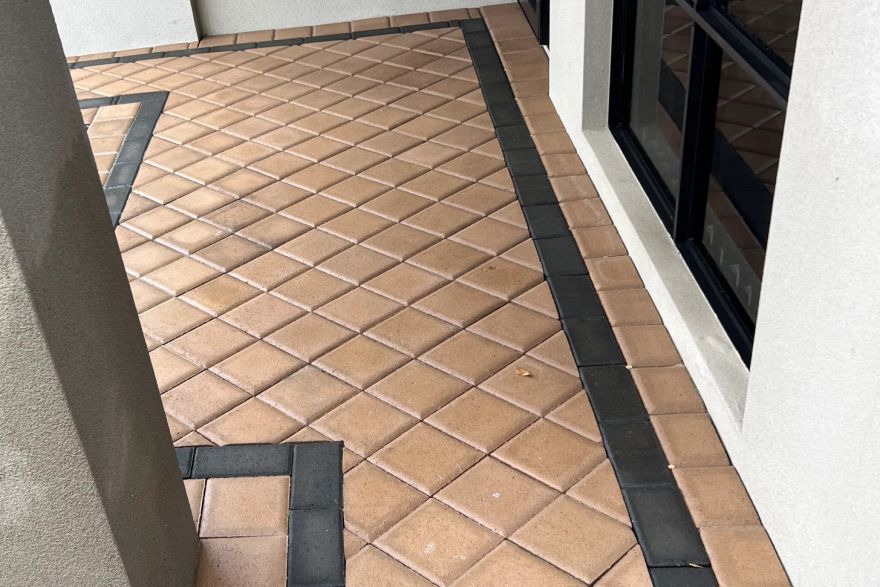 Before and after cleaning on brick pavers · Path: after