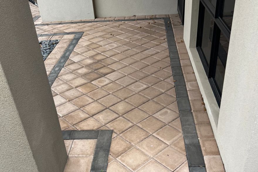 Before and after cleaning on brick pavers · Path: before
