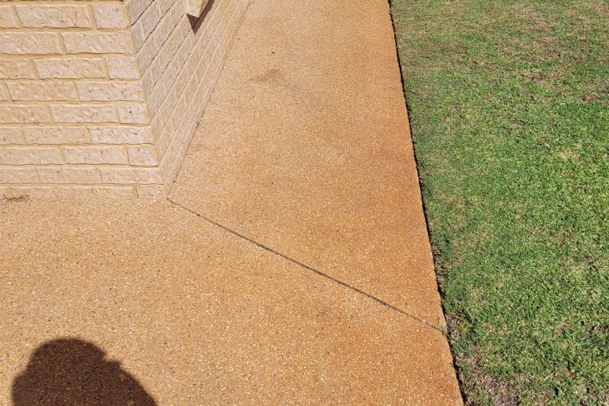 Before and after rust / bore stains on concrete exposed aggregate · Driveway: before