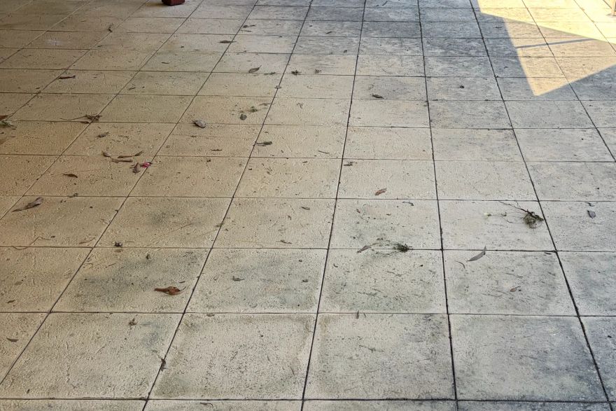 Before and after cleaning on sandstone pavers · Patio / alfresco: before