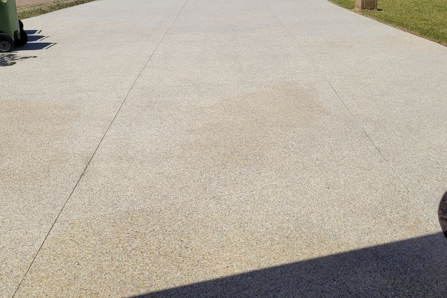 Before and after cleaning on concrete exposed aggregate · Driveway: after