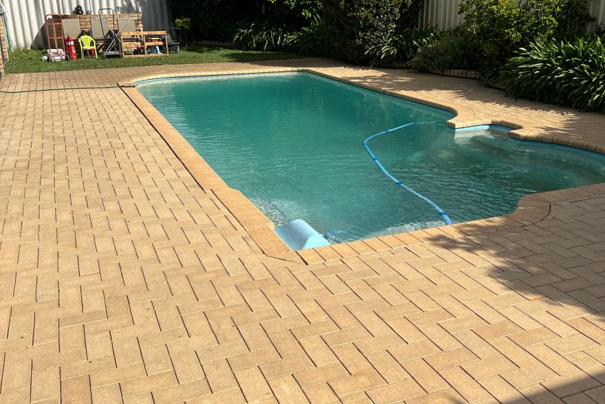 Before and after cleaning on brick pavers · Poolside: after