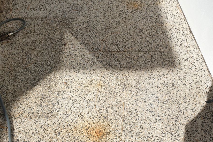 Before and after rust / bore stains on concrete exposed aggregate: before
