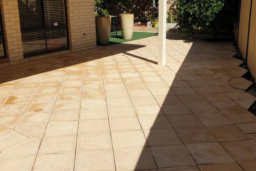 Before and after cleaning on sandstone pavers · Patio / alfresco: after