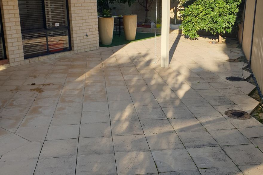 Before and after cleaning on sandstone pavers · Patio / alfresco: before