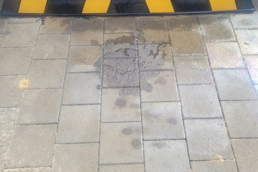 Before and after oil stains on brick pavers: before