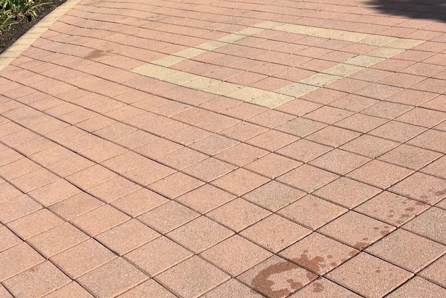 Before and after cleaning on brick pavers · Driveway: after