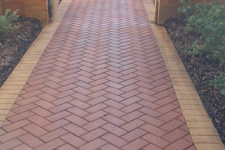Before and after cleaning on brick pavers · Path: after