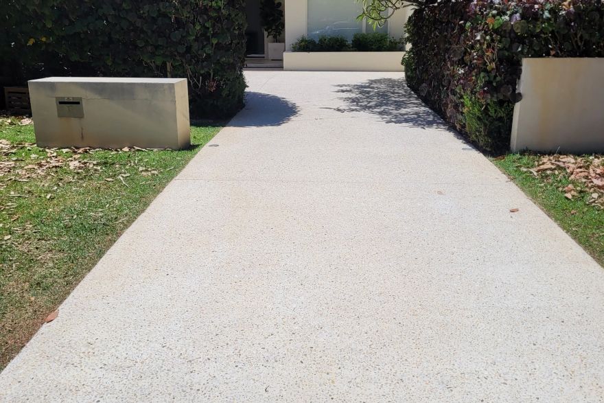 Before and after cleaning on concrete exposed aggregate · Driveway: after