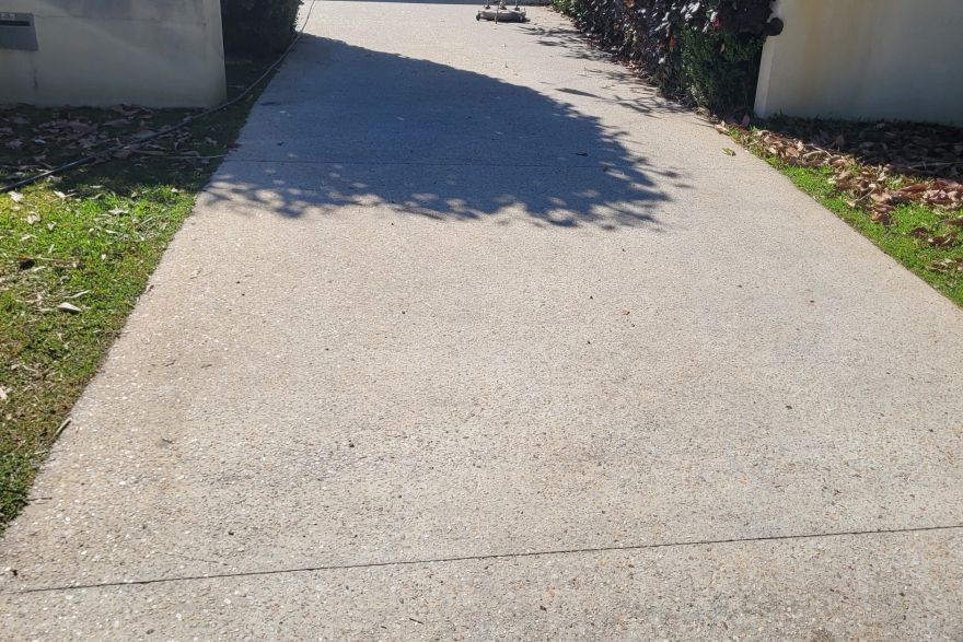 Before and after cleaning on concrete exposed aggregate · Driveway: before