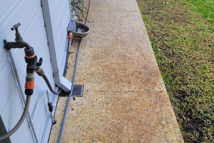Before and after rust / bore stains on concrete exposed aggregate: before