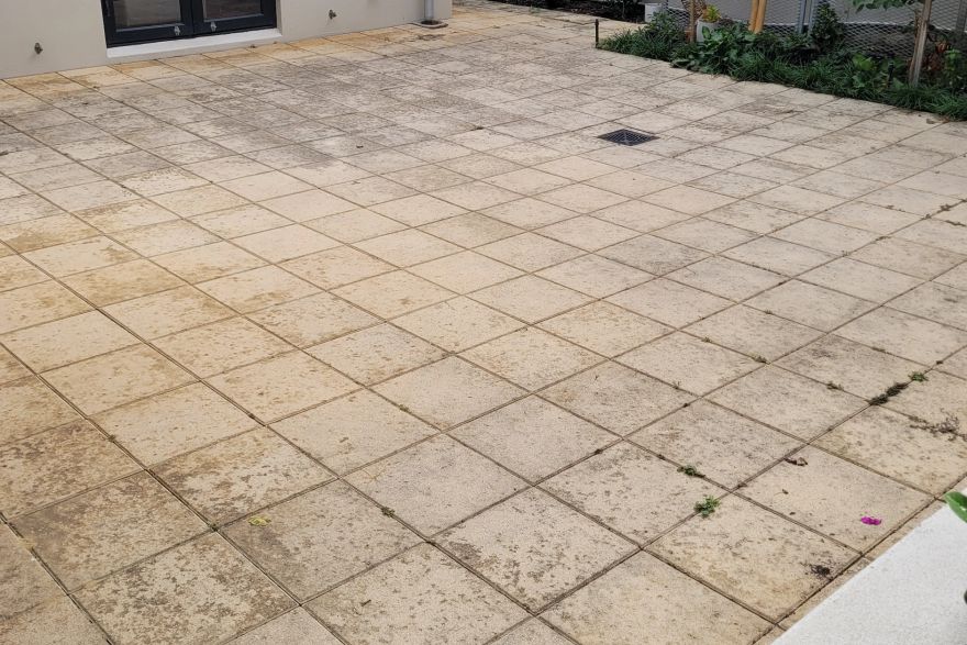 Before and after cleaning on sandstone pavers: before