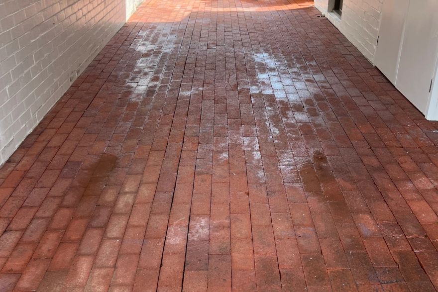 Before and after cleaning on brick pavers · Garage floor: after